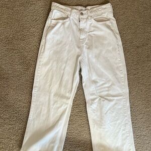 White jeans with frayed bottoms